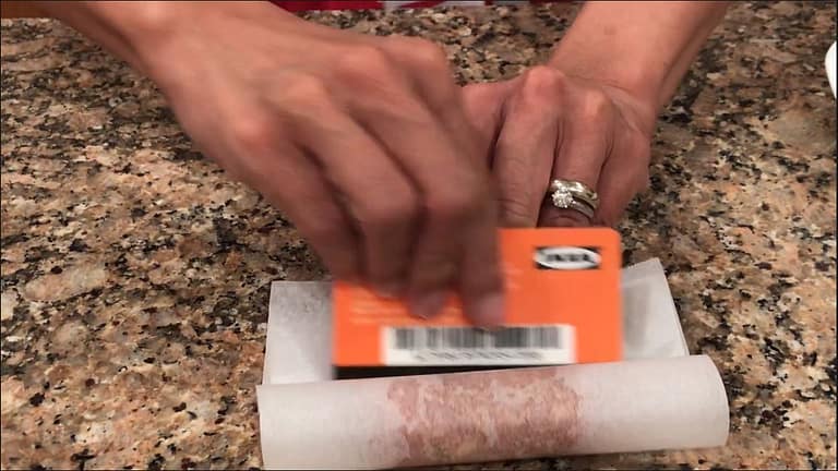 using a credit card with paper to form a sausage