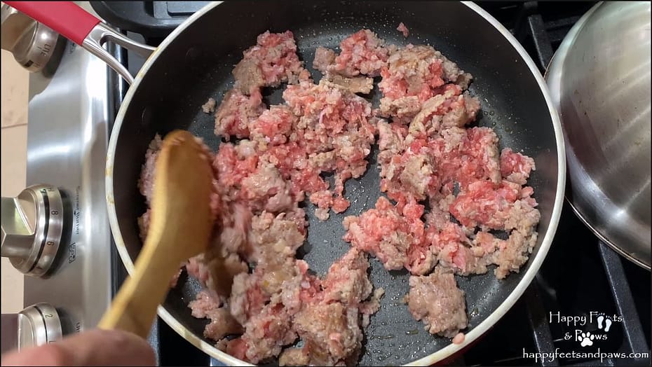 sausage being cooked in a pot for biscuits and gravy recipe