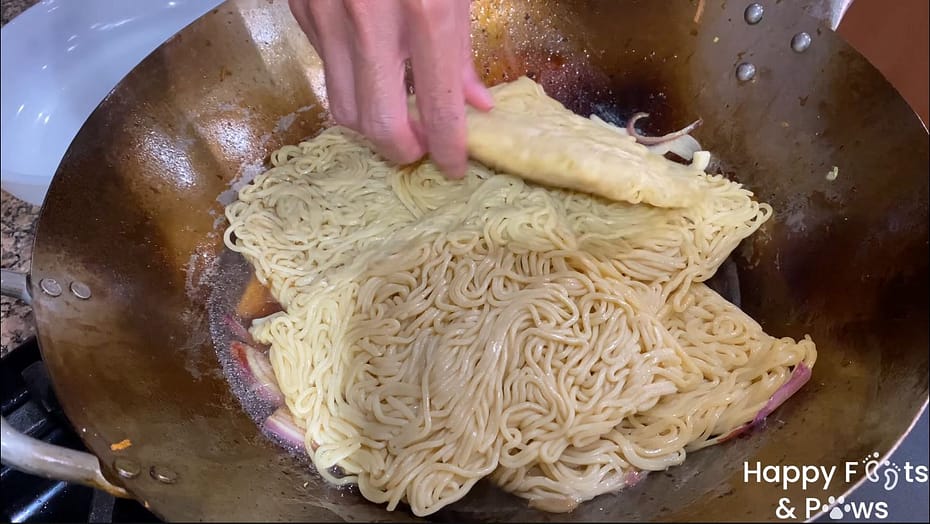 Adding the Yakisoba noodles to the Wok