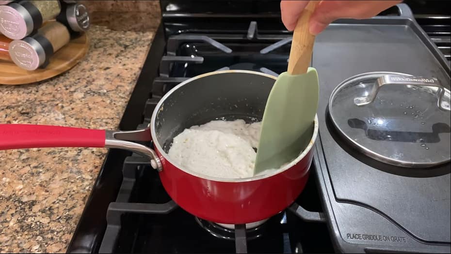 coconut milk simmering in a pan on a stove
