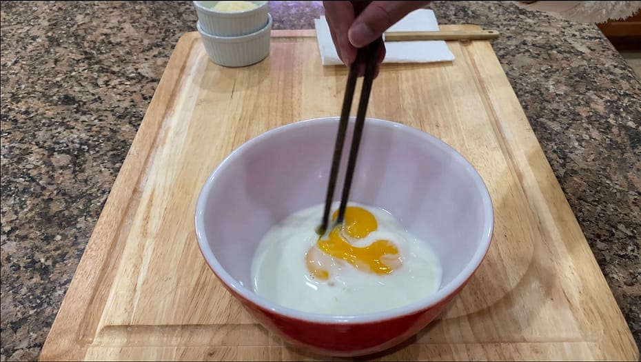 Mixing the custard toppings with chopsticks