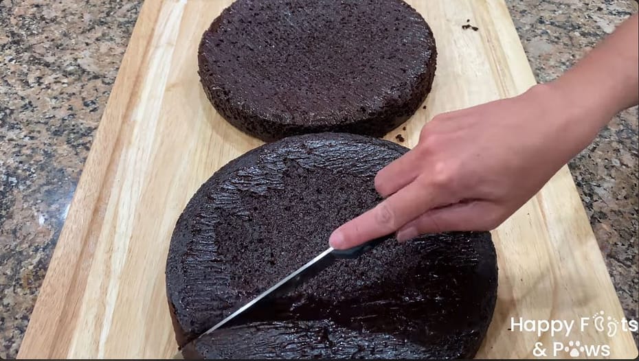 Cutting the cake into pieces on a cutting board with a knife