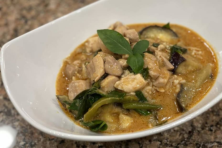 Bowl of panang thai curry with chicken. Includes Chicken, beans, eggplant, basil, and peanutbutter