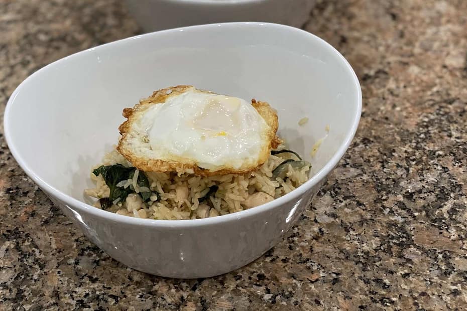 thai chicken fried rice with basil in a bowl. Fried egg on top