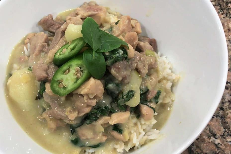 homemade thai green curry in a bowel with fresh basil and peppers