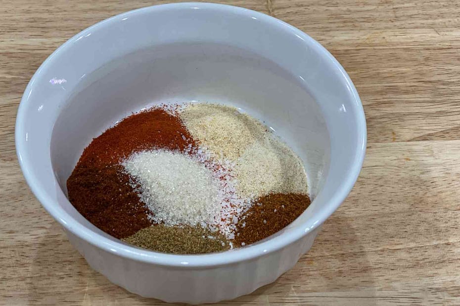 Fajita Seasoning in a bowl with cumin, chili powder, paprika, garlic powder, onion powder, cayenne pepper, kosher salt, and brown sugar