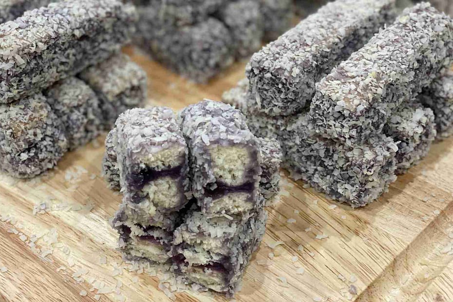 Filipino Ube Bars stacked on a wooden cutting board