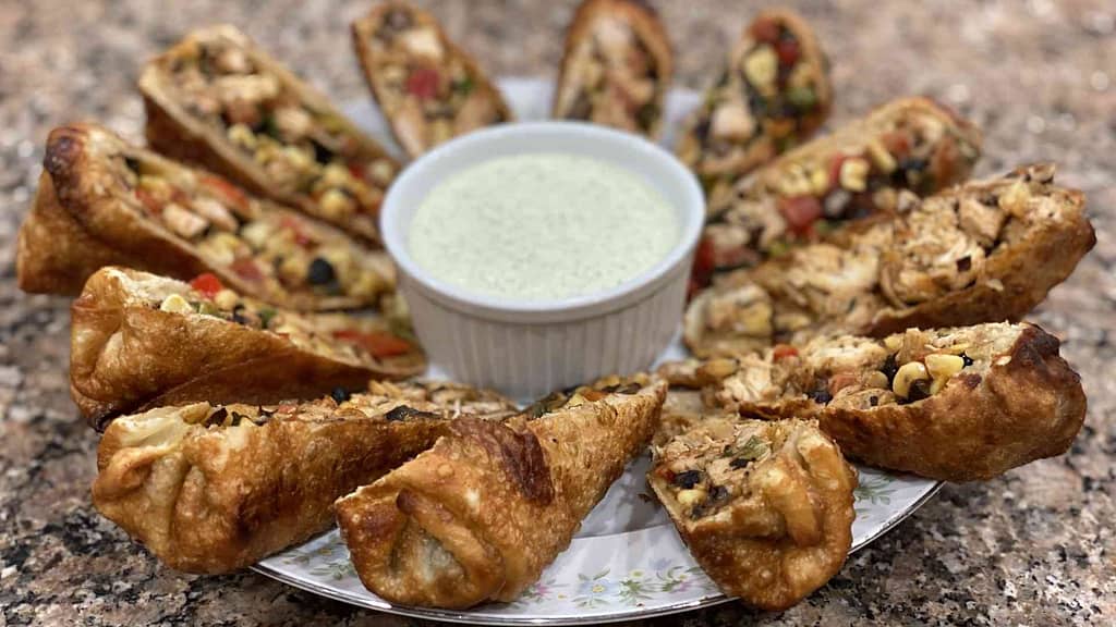 Southwest egg rolls on a plate with cucumber aioli sauce