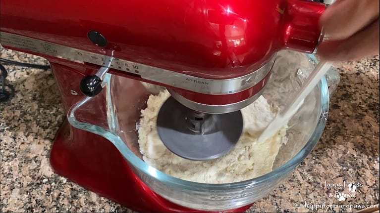 flour being mixed in a stand mixer for biscuits and gravy recipe