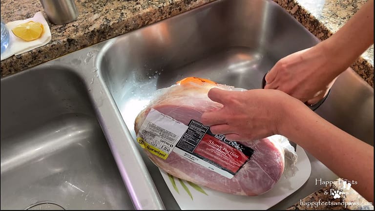 defrosted ham in sink being opened