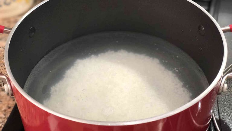 rice being cooked in pot for champorado