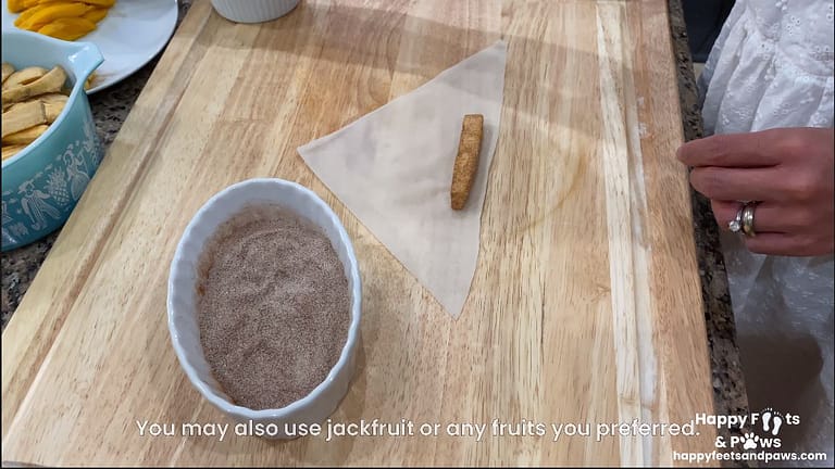woman adding plantain banana to egg roll wrapper