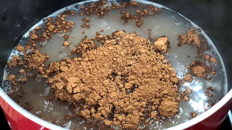 cocoa being disolved in a pot for champorado