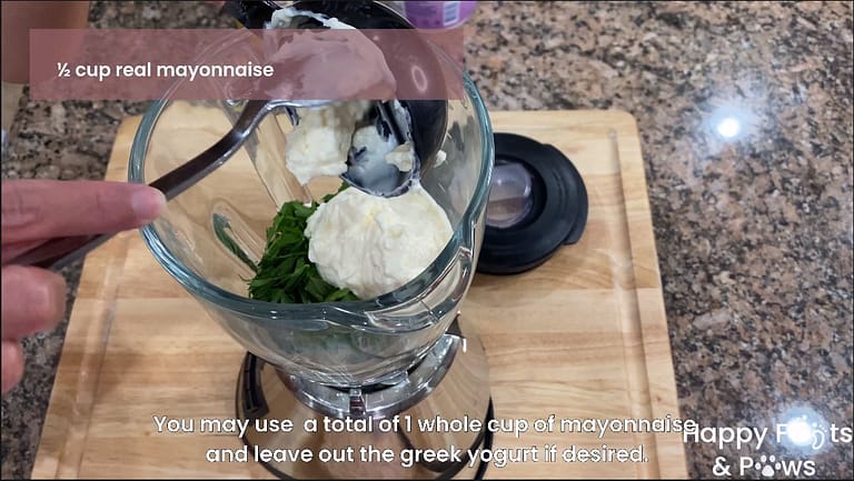 mayonnaise being added to a blender for creany garlic dressing