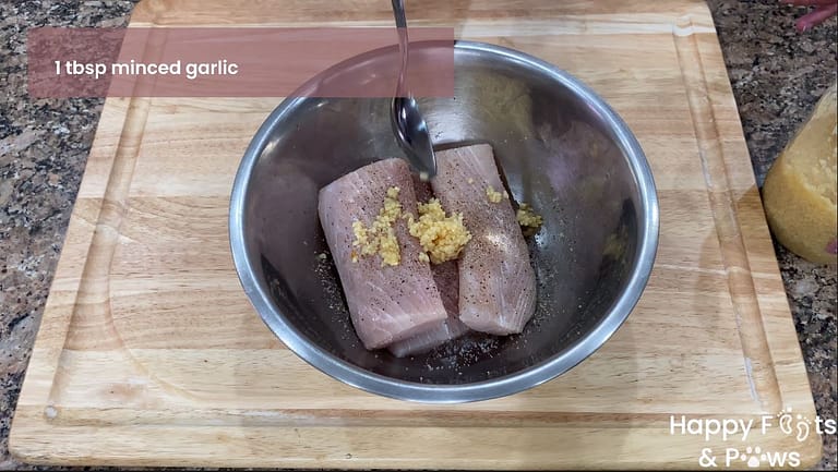 mahi mahi fish in a bowl with ingredients for fish marinade