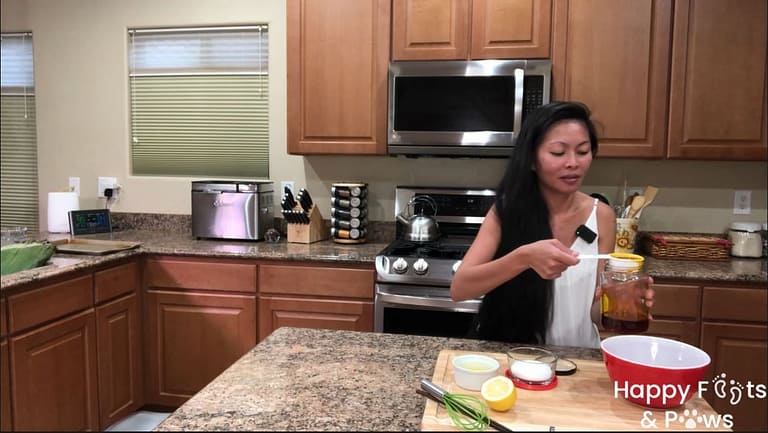 woman adding annato oil to chicken inasal basting sauce