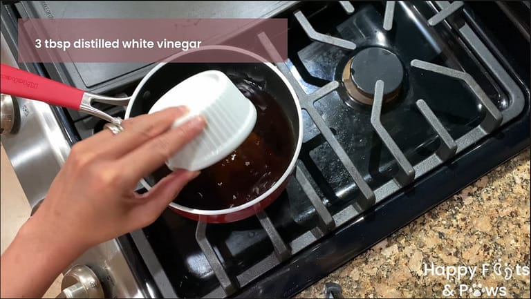 Adding ingredients to sweet and sour sauce in a pot on a stove