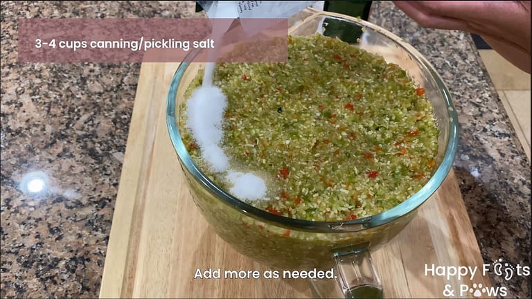 pouring pickeling salt on top of ingredients for zucchini relish recipe