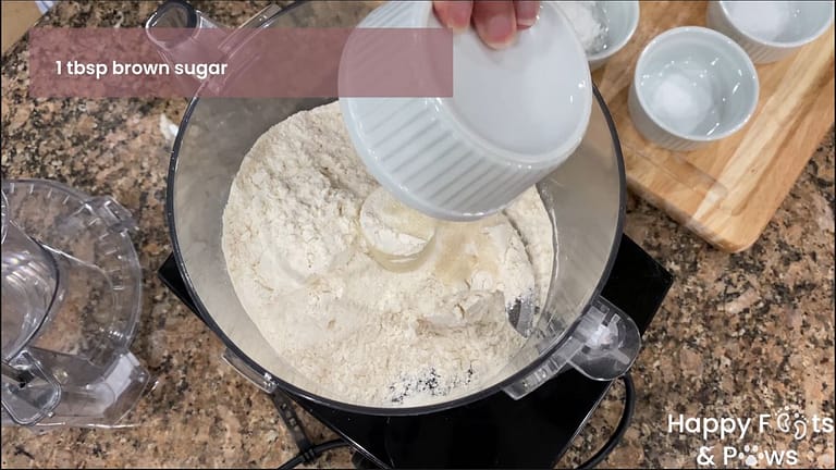 Adding brown sugar to mixer for ube bars dough