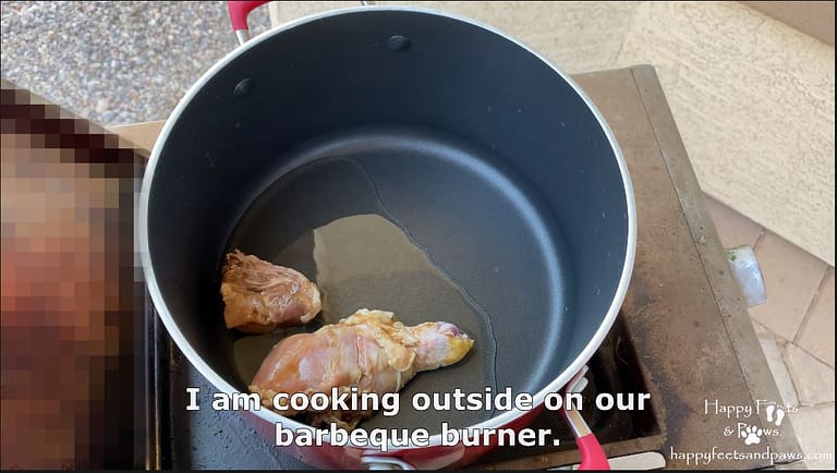 cooking meat in a pot with oil on a bbq for Filipino Adobo recipe.