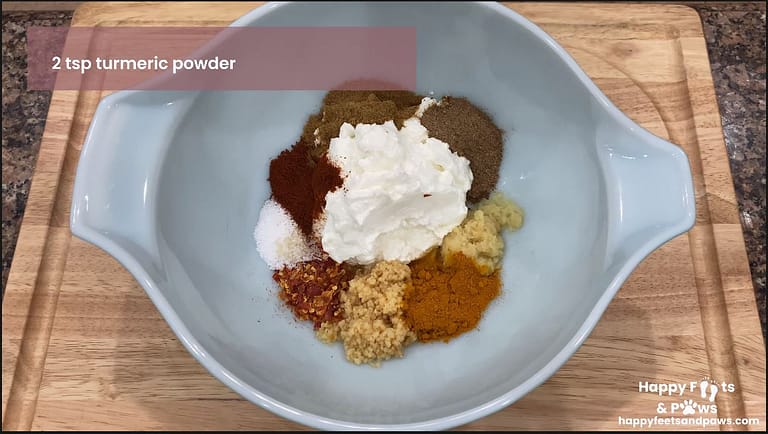 Spices and yogurt being added to a bowl for chicken tikka masala recipe
