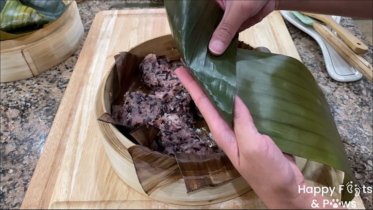 folding banana leaves to wrap puto maya rice cakes