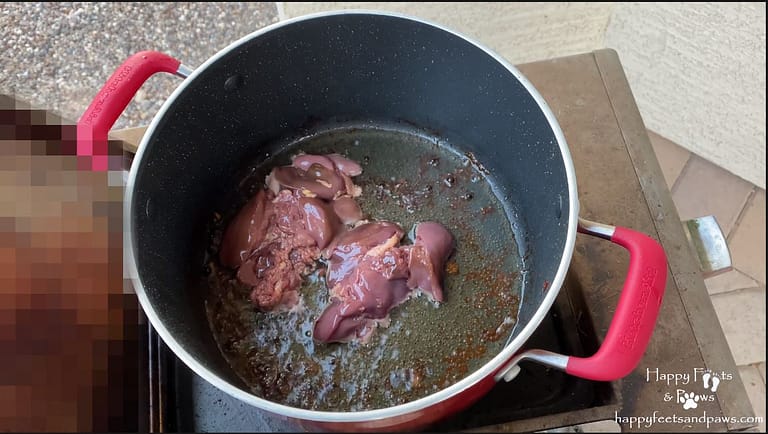 chicken liver cooking in a pot on a bbq for Filipino Adobo recipe.