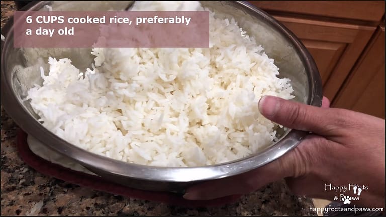 Seperating rice grain with a fork in prep for thai chicken fried rice recipe