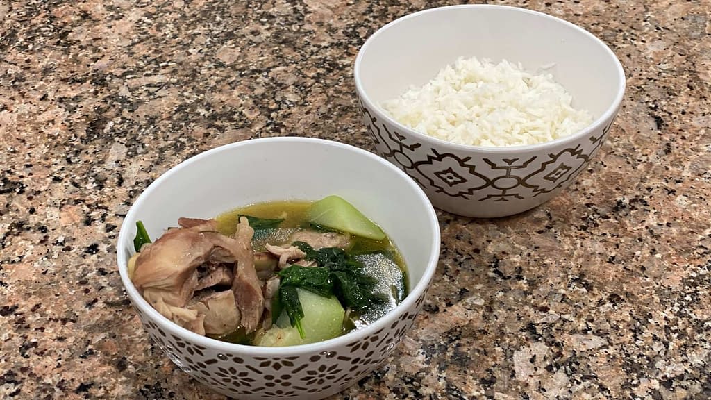 A bowl of Tinolang Manok with white rice on the side