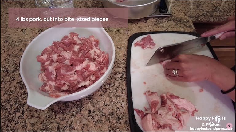 raw pork being chopped for Pork Guisantes recipe
