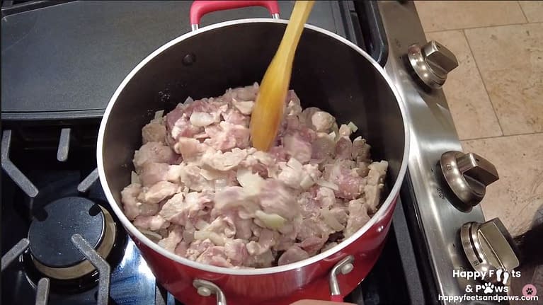 pork being cooked in a pot for Pork Guisantes recipe