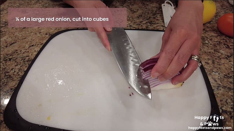 choppping an onion on a cutting board for guacomole recipe