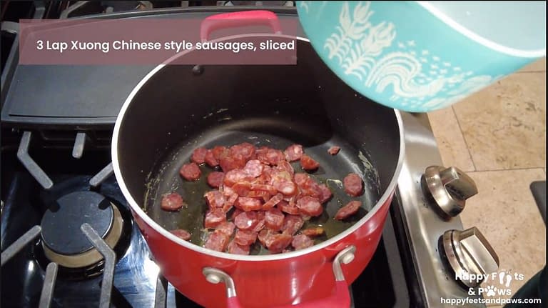 Lap xuong sausage being cooked in a pot for Lap Xuong Fried Rice recipe