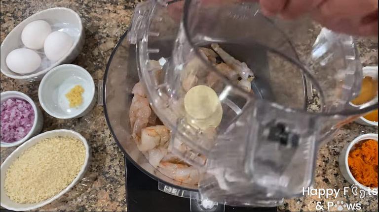 adding shrimp to food processor for Shrimp Cakes with Beurre Blanc Sauce