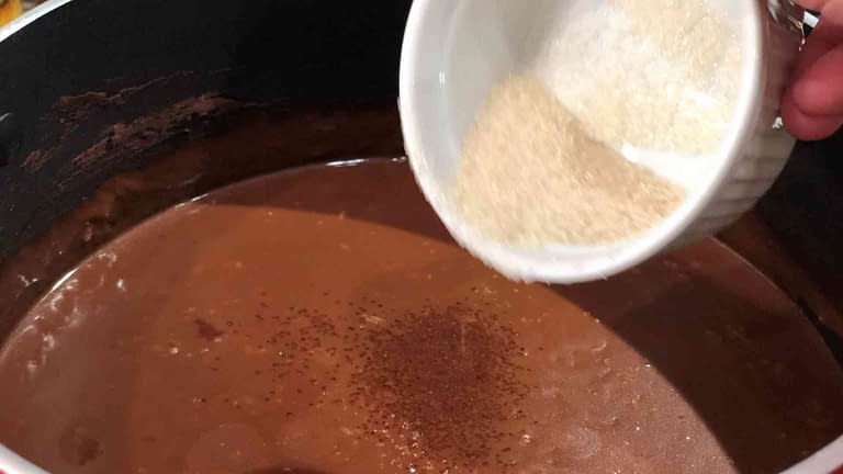 sugar being added to champorado