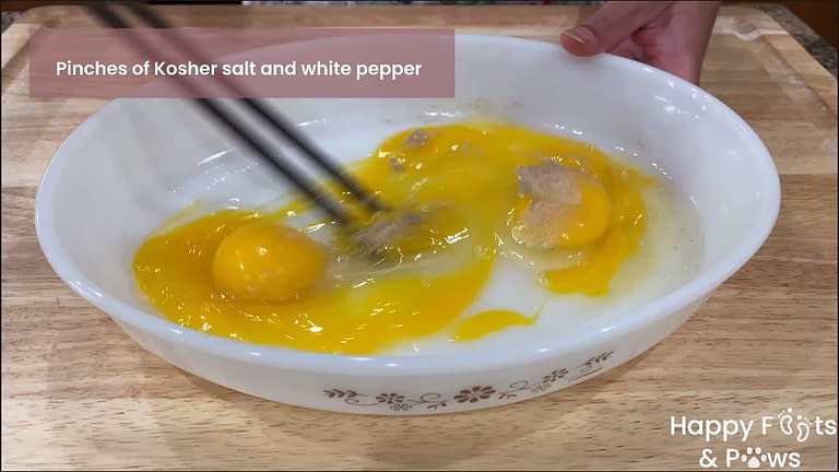 whisking 3 eggs in a glass bowl for filipino grilled eggplant omelet recipe