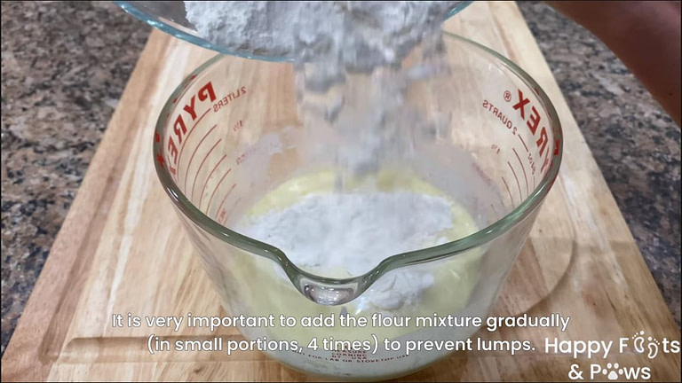Mixing flour into a large pyrex glass with wet ingredients