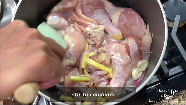 chicken being cooked in pot for tinolang manok recipe
