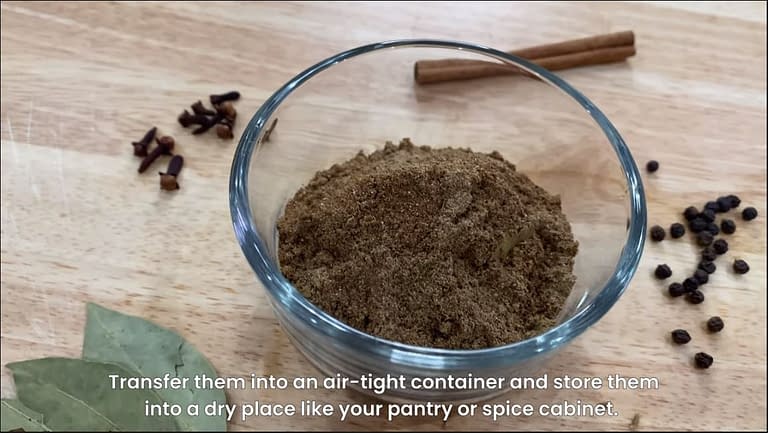 garam masala in a cup with ingredients a long side.