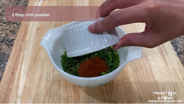 adding chili powder to bowl for chicken marinade recipe