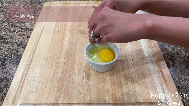 cracking egg in dish for egg wash