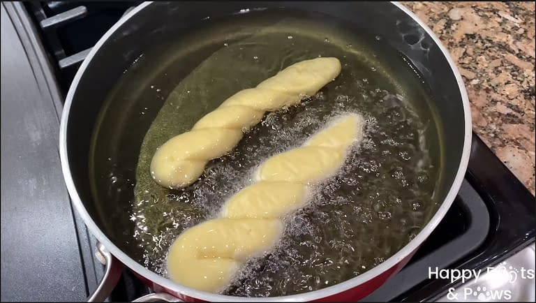 frying shakopy in a pot with oil