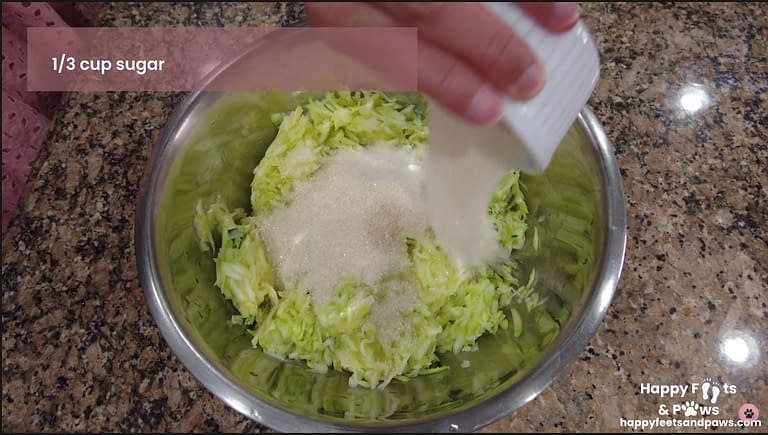 Sugar being added to zucchini bread batter